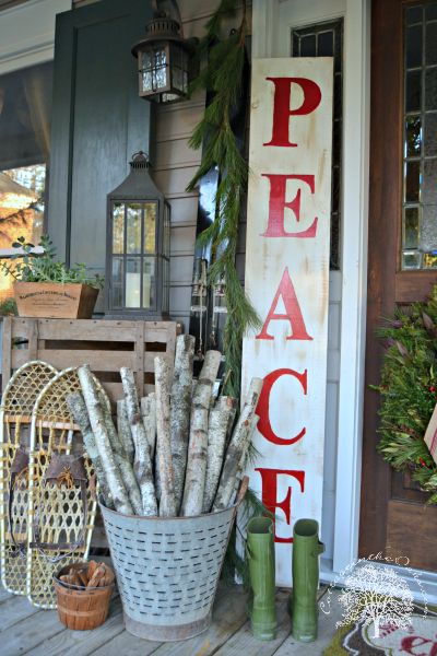 Christmas porch with Peace sign and birch logs